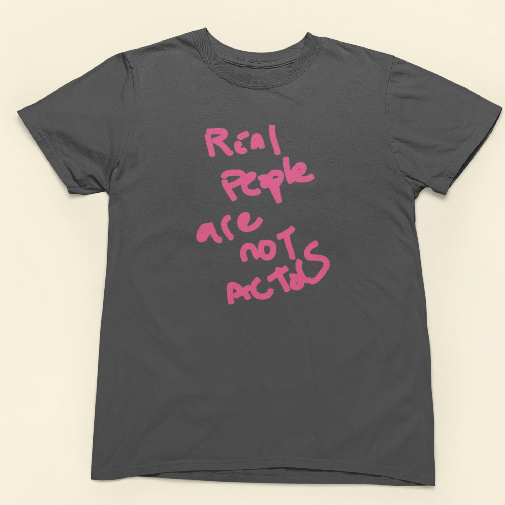 Gray t-shirt with pink text on a beige background