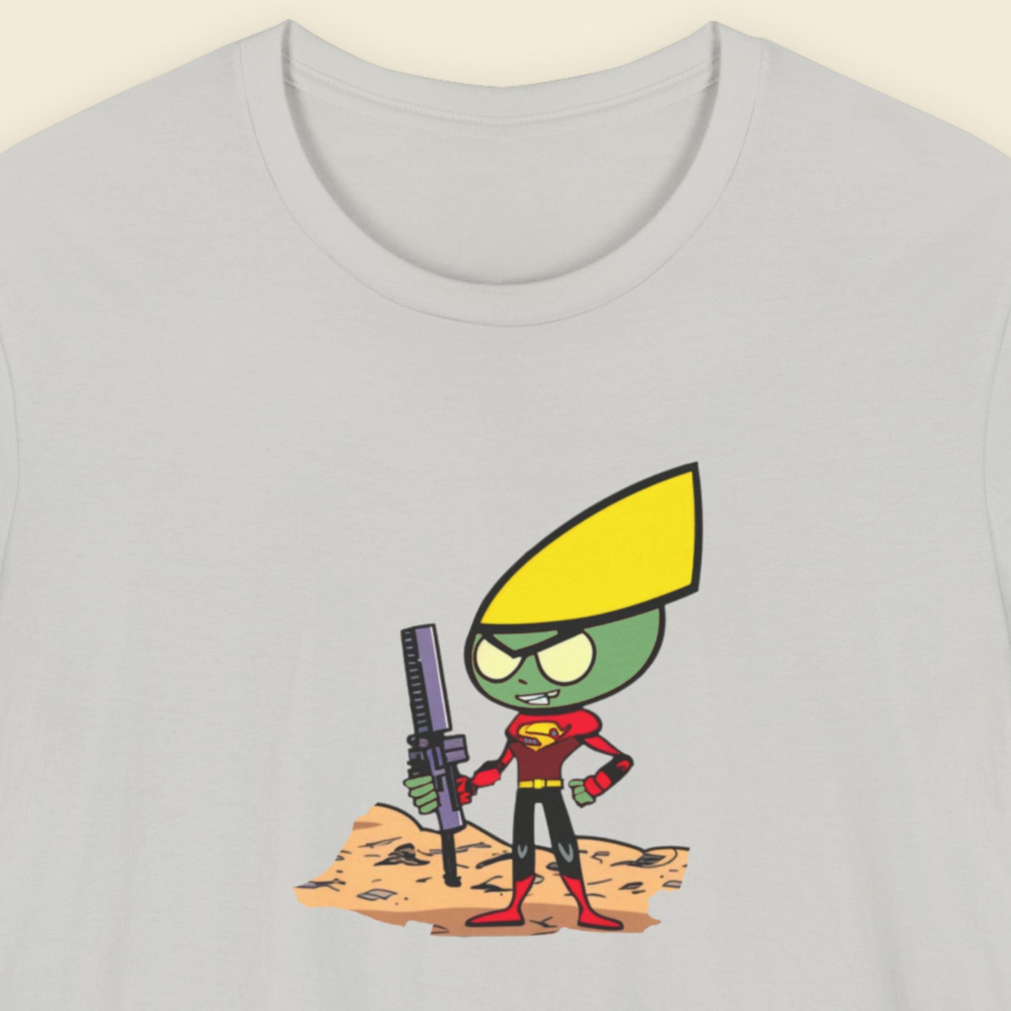 Grey shirt with a fun, colorful cartoon illustration on a beige background.
