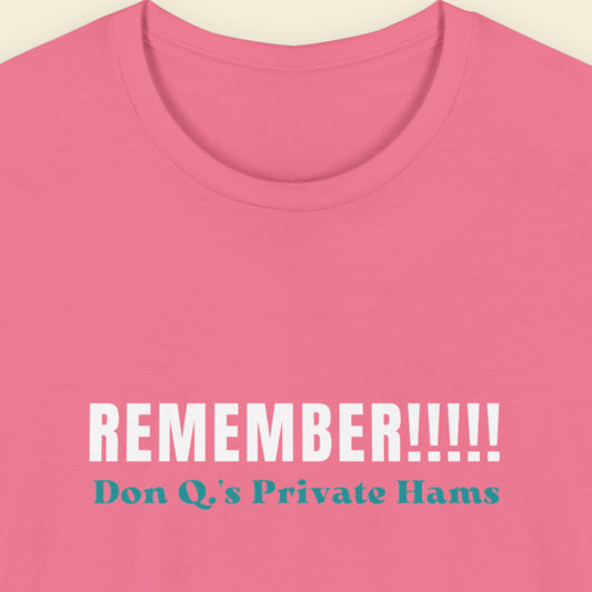 Pink t-shirt with white and blue text on a beige background.