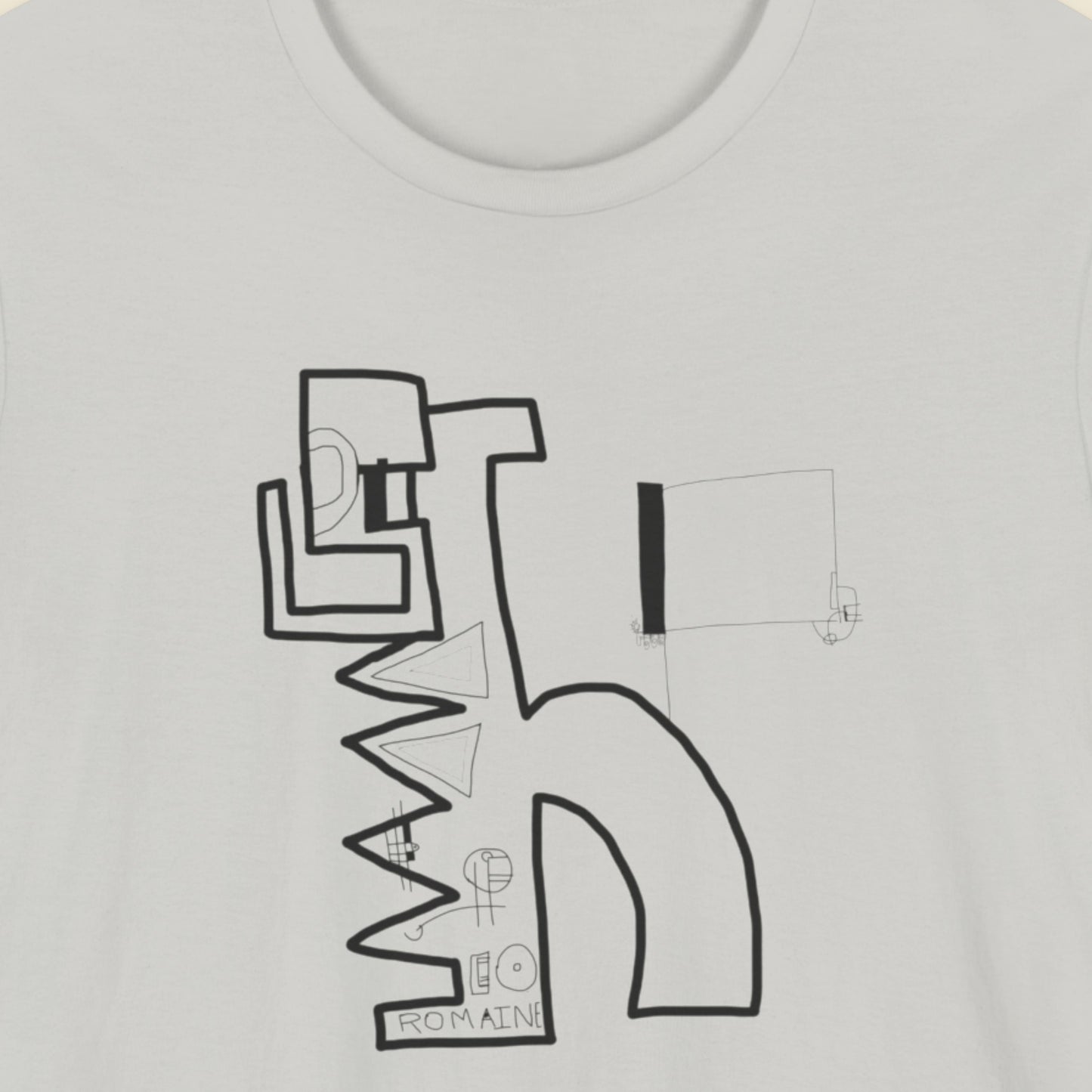 Light grey t-shirt with an abstract line drawing on a beige background.