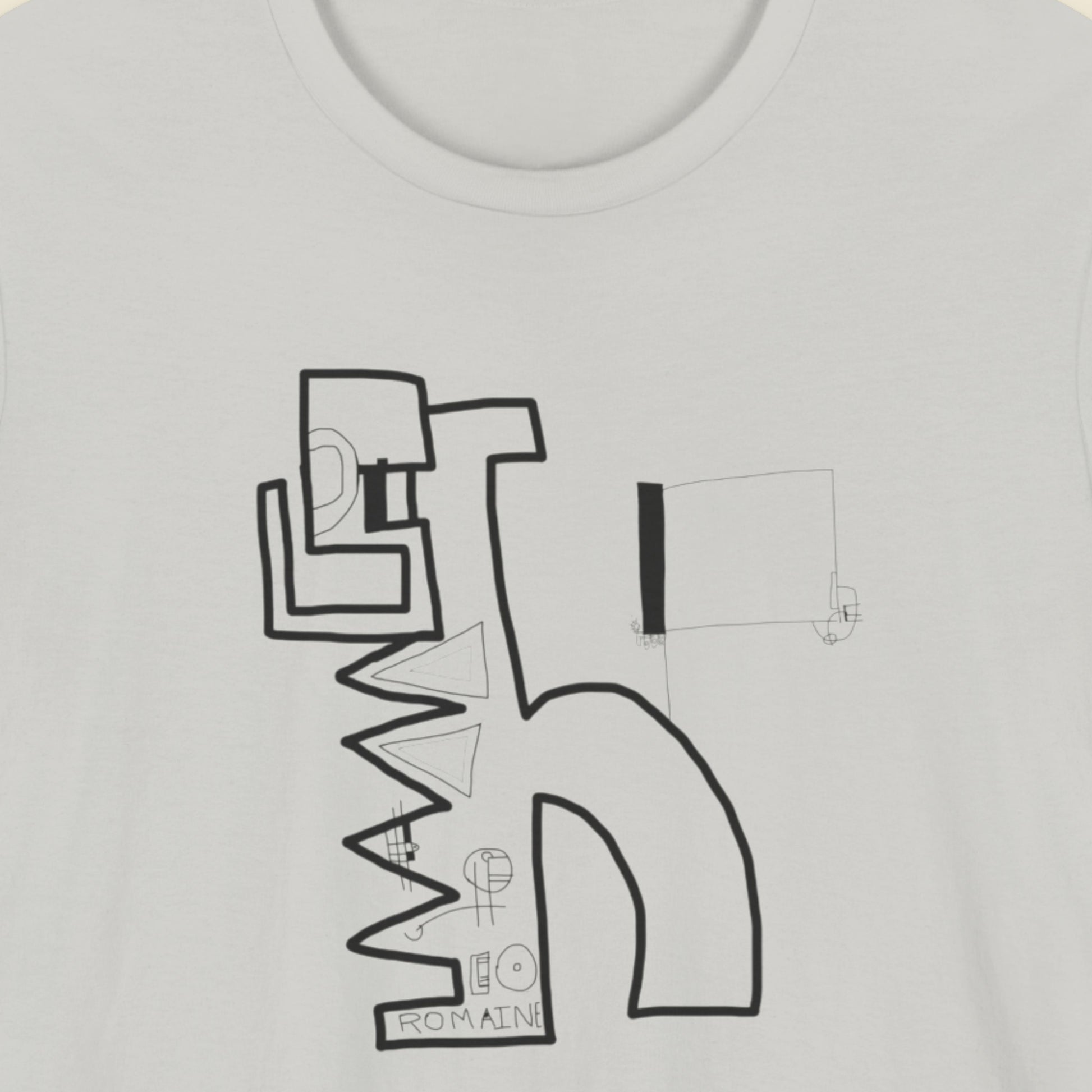 Light grey t-shirt with an abstract line drawing on a beige background.