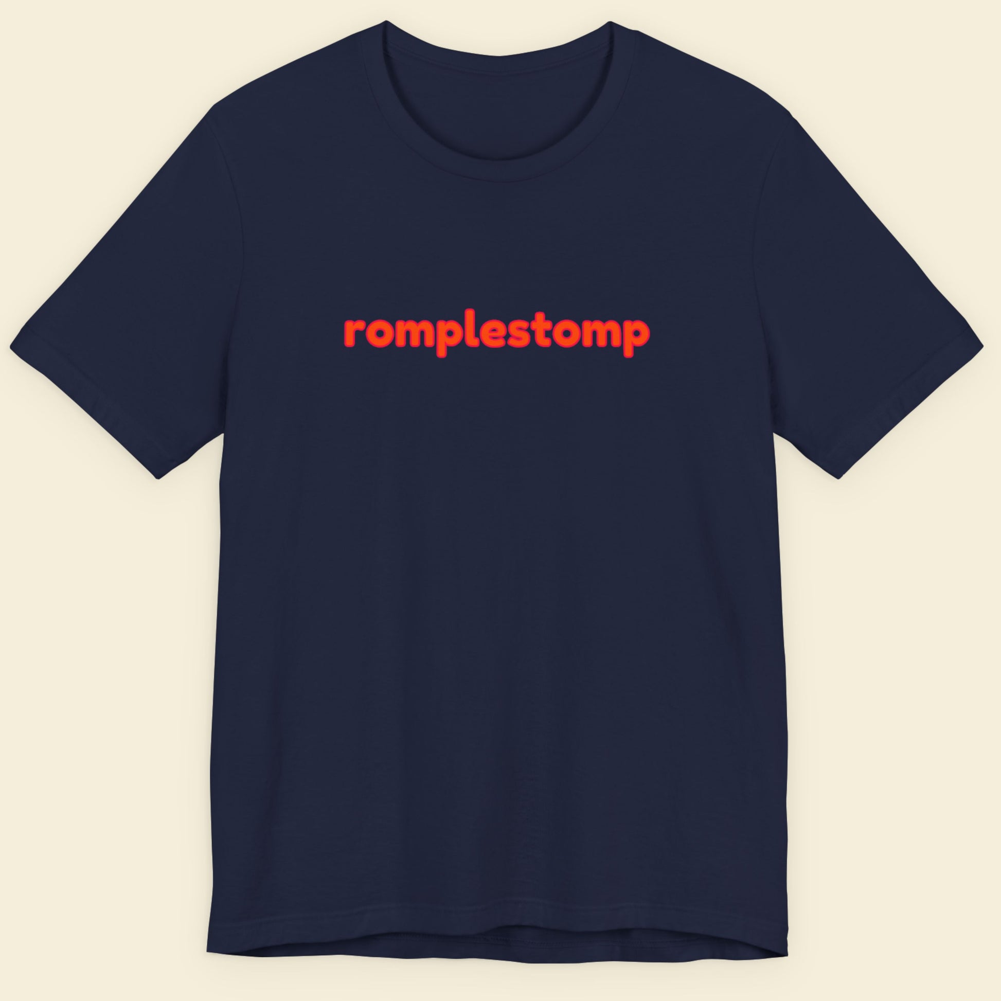 Navy blue Black t-shirt with multicolored 'romplestomp' text on a beige background.