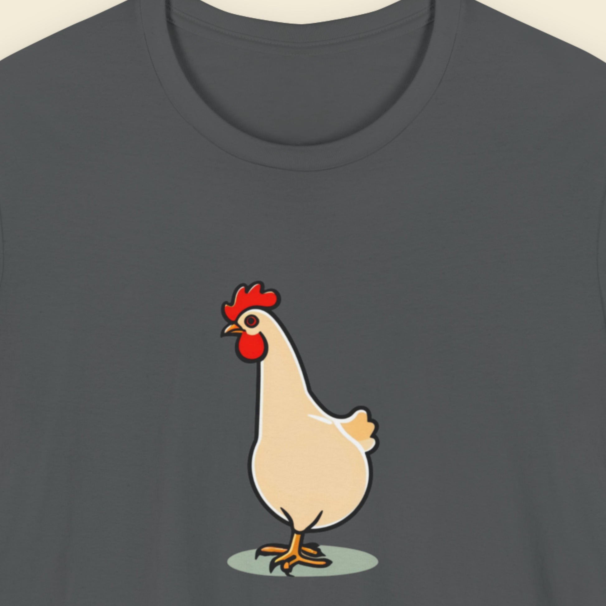 Grey t-shirt with an illustration of a rooster on a beige background.