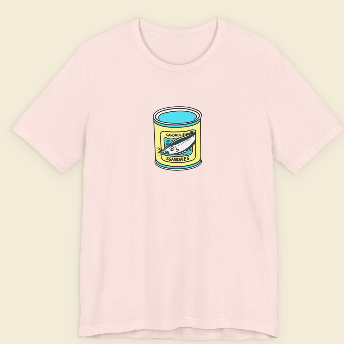 pink shirt with a can of fish design on a beige background.