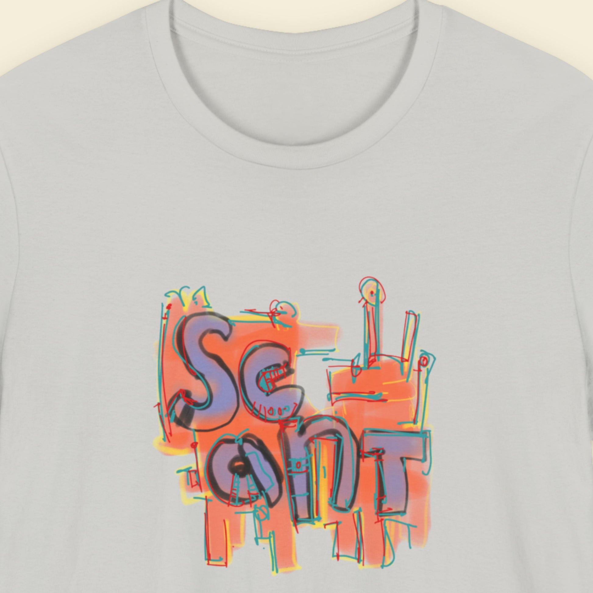 Light grey t-shirt with a colorful abstract drawing on a beige background.