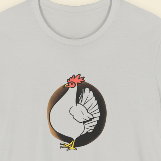 Light grey t-shirt with a drawing of a chicken on a beige background.
