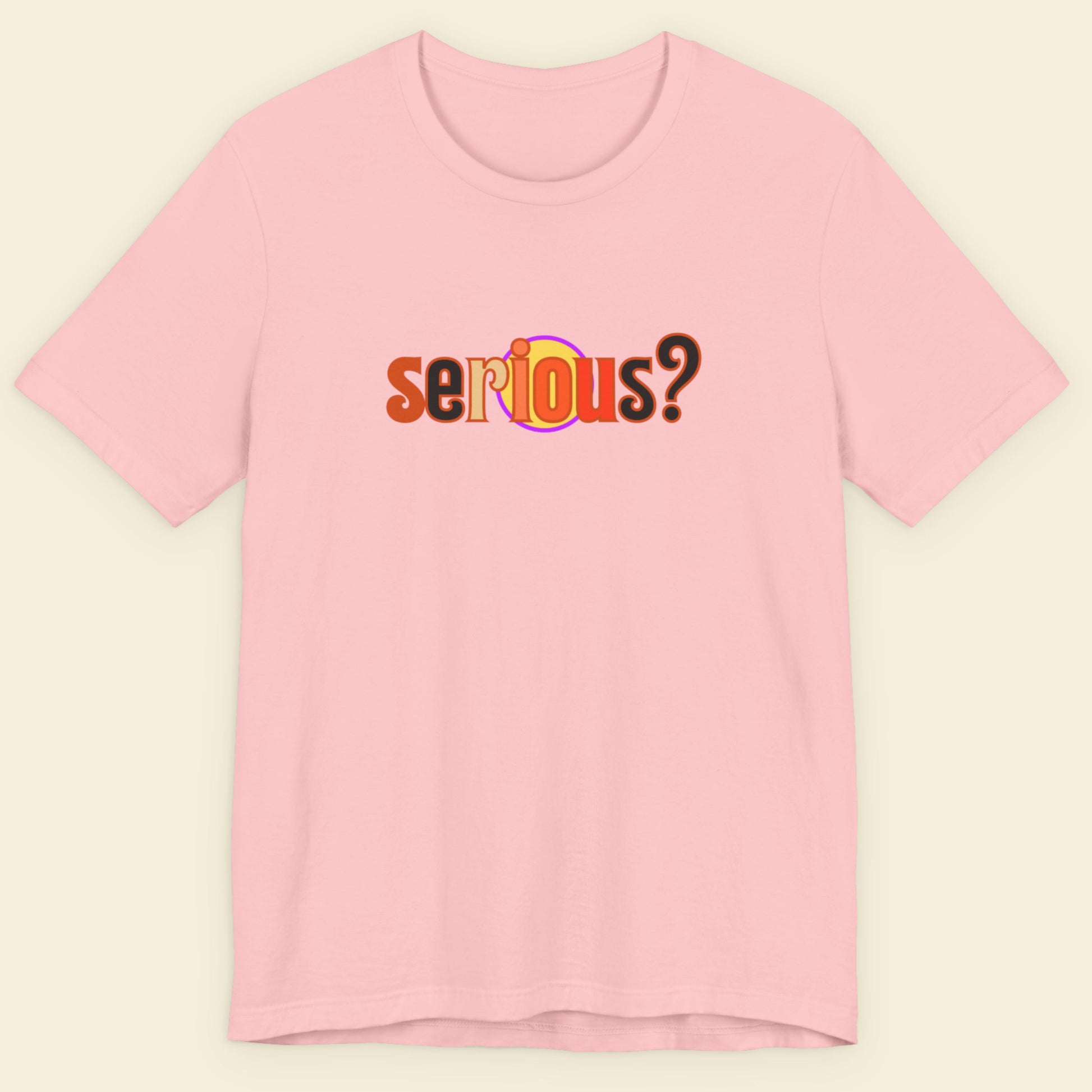 Pink t-shirt with 'serious?' text on a beige background.