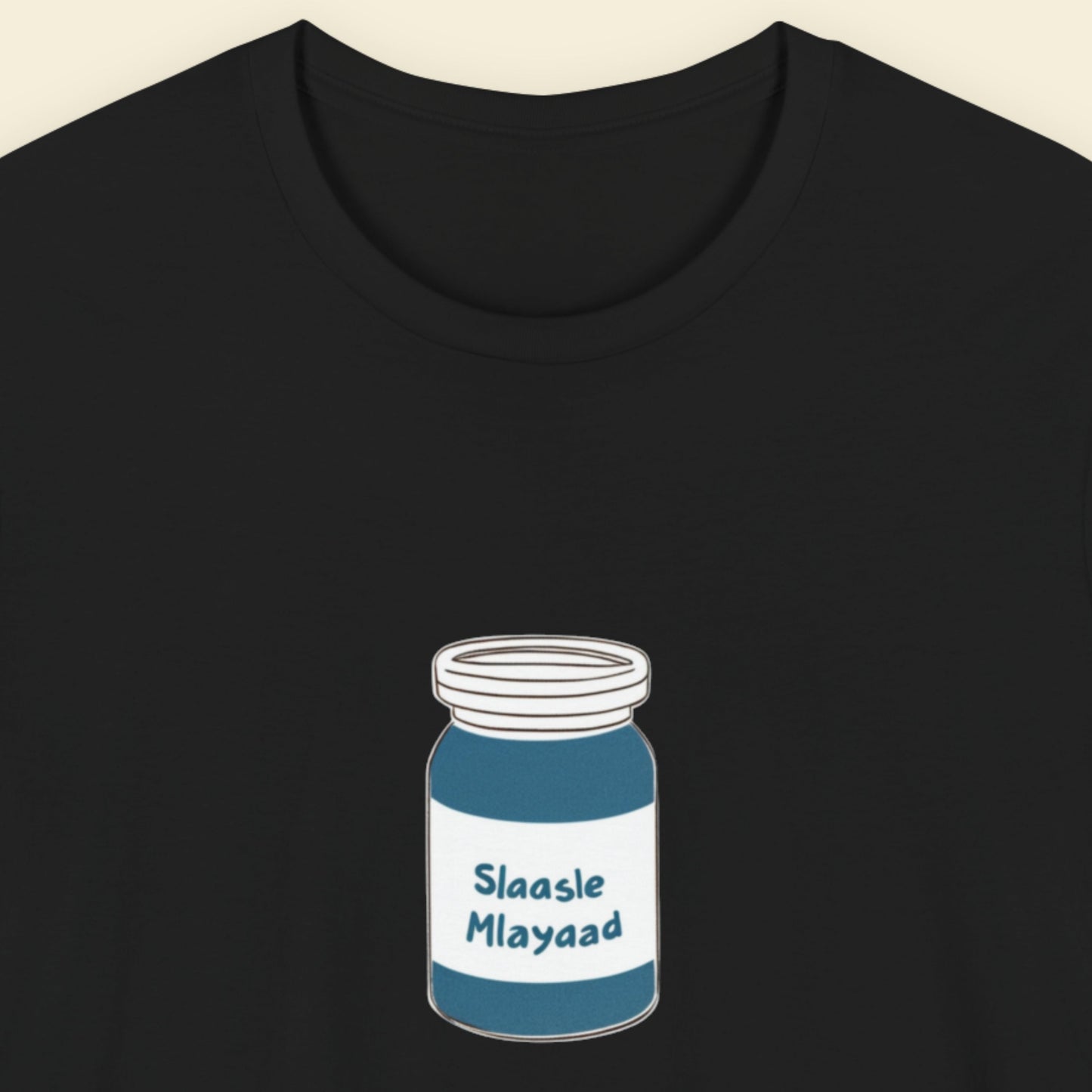 Black t-shirt with a drawing of a jar of Slaasle Mlayaad on a beige background.