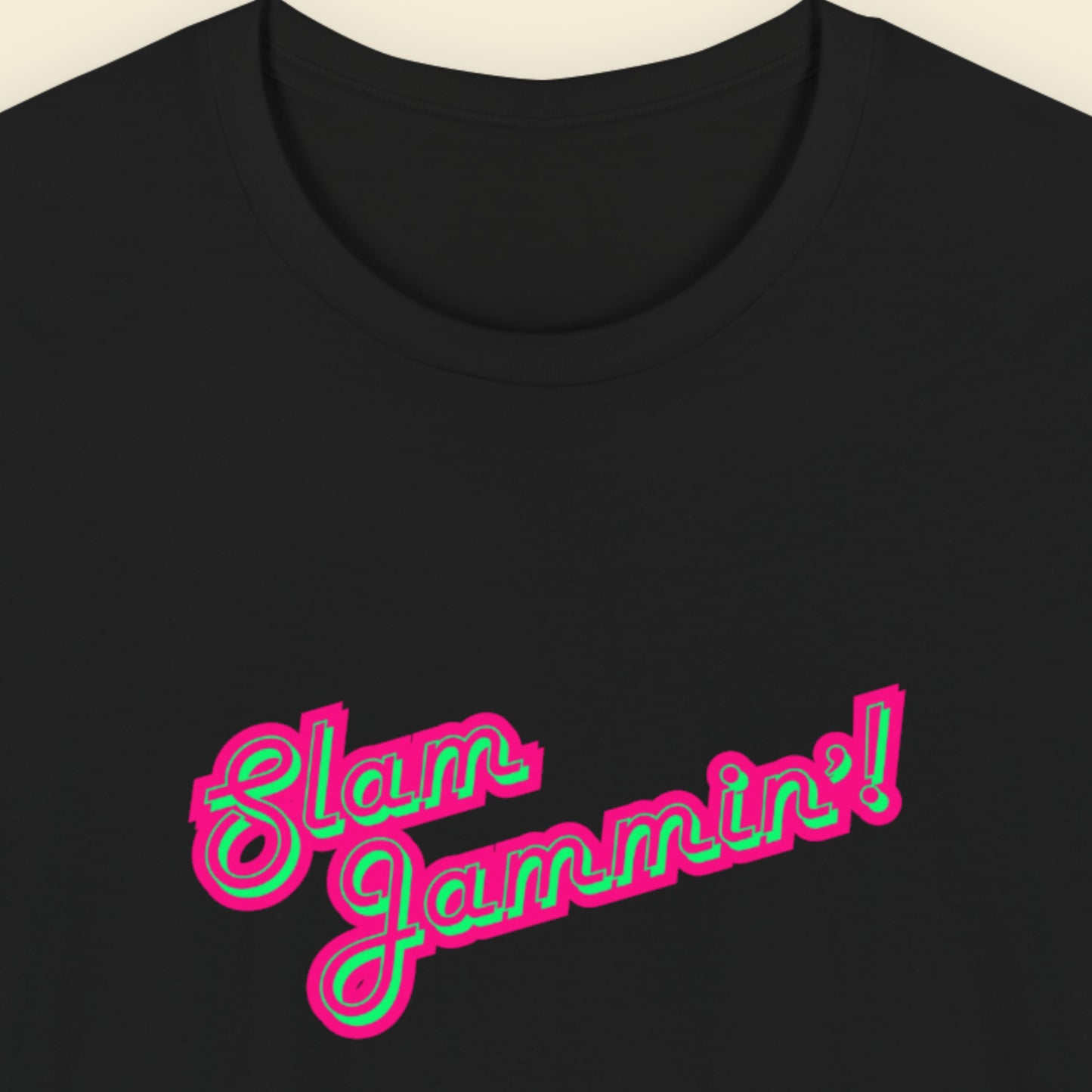 Black tee with multi-colored humorous text on a beige background.