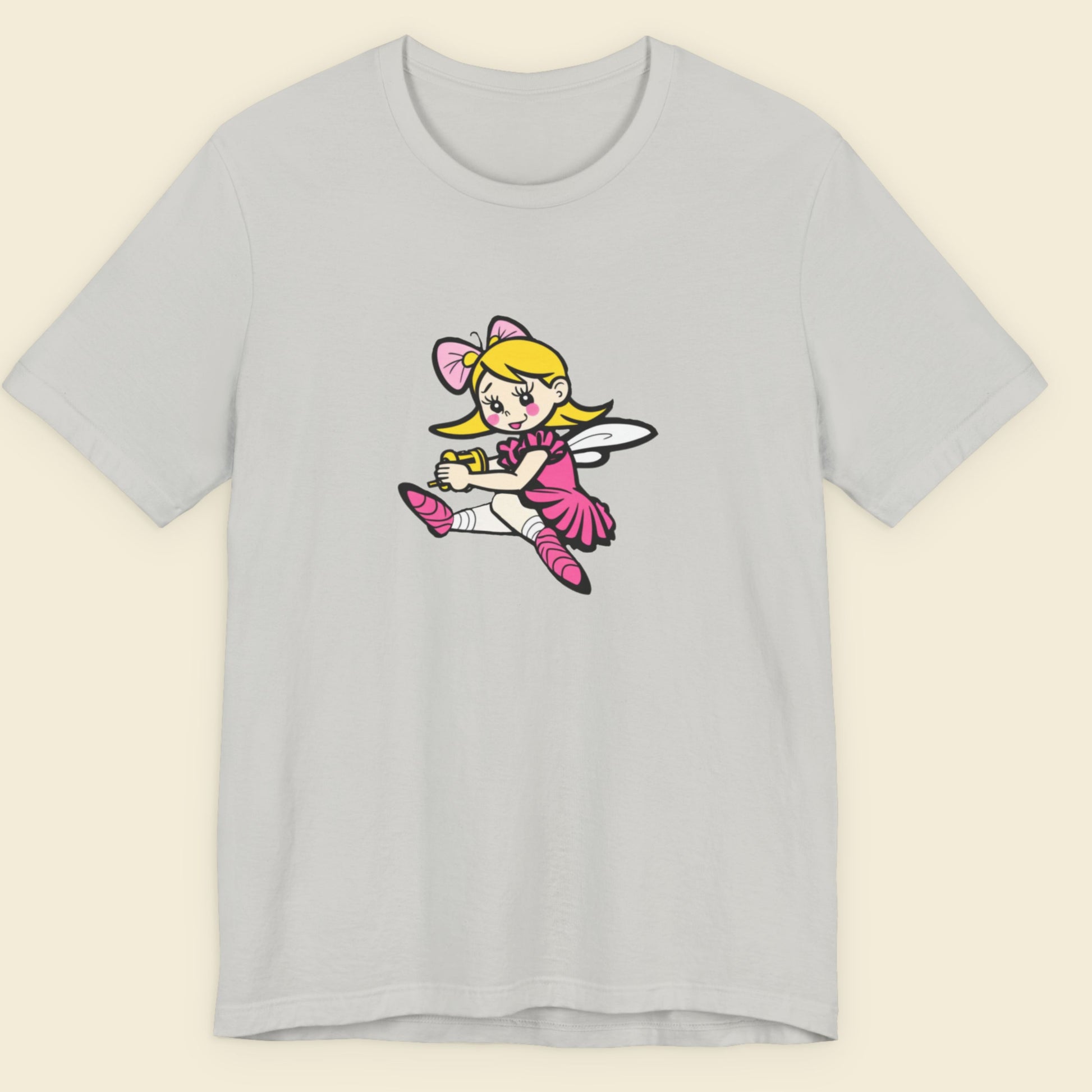 Light grey t-shirt with a fun, colorful cartoon fairy illustration on a beige background.