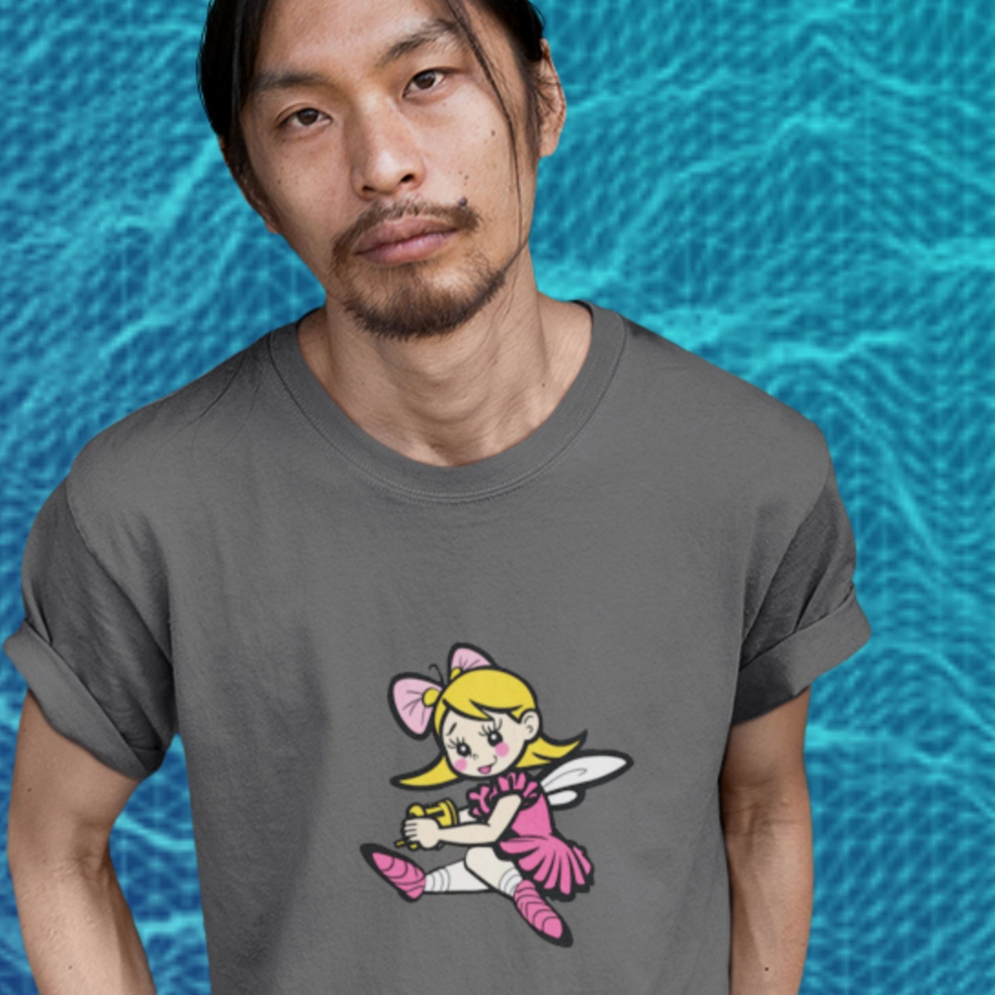 Man wearing a dark grey t-shirt with a fun, colorful cartoon fairy illustration in front of a pool.