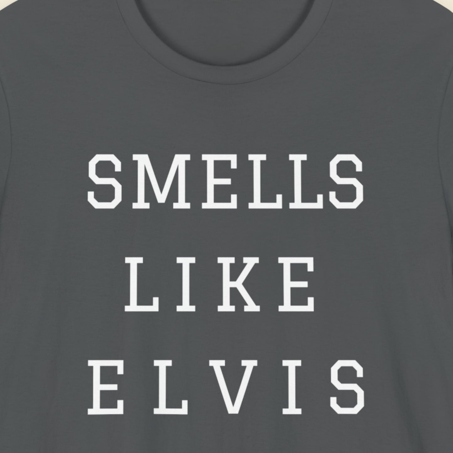 Gray t-shirt with 'SMELLS LIKE ELVIS' text in white on a plain background.