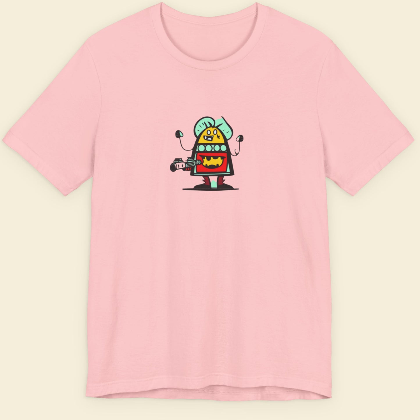 Pink shirt with a fun, colorful cartoon alien illustration on a beige background.