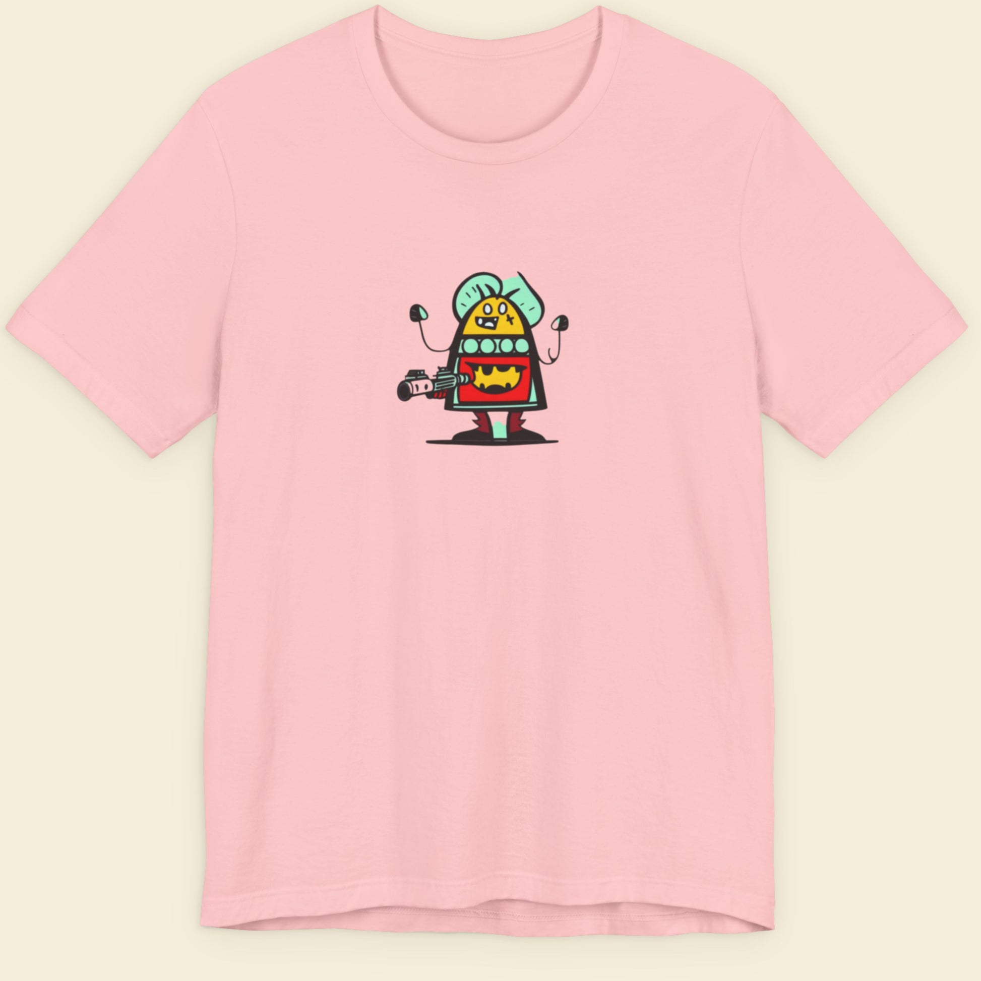 Pink shirt with a fun, colorful cartoon alien illustration on a beige background.