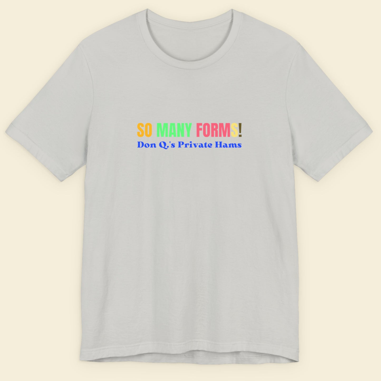 Light grey tee with humorous colorful text on a beige background.