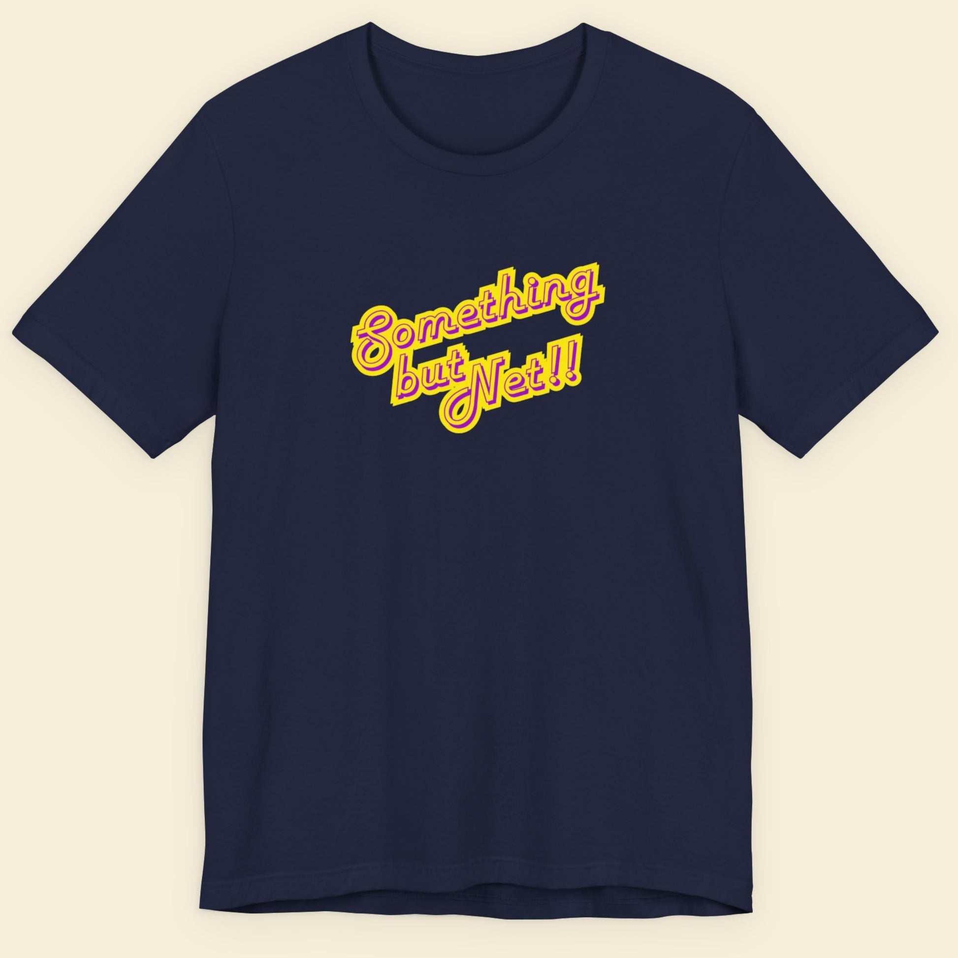 Navy t-shirt with humorous colorful text on a beige background.