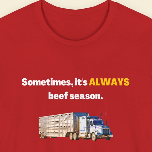 Red shirt with humorous text and truck graphic on a beige background.