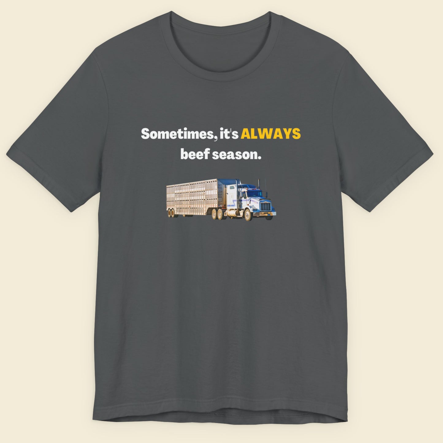 Gray t-shirt with a truck graphic and text on a beige background.