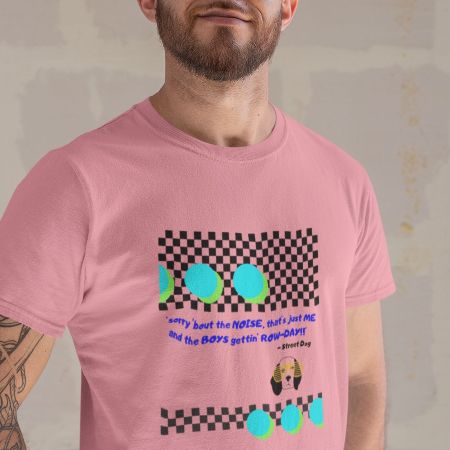Person wearing a pink t-shirt with colorful graphics and text.