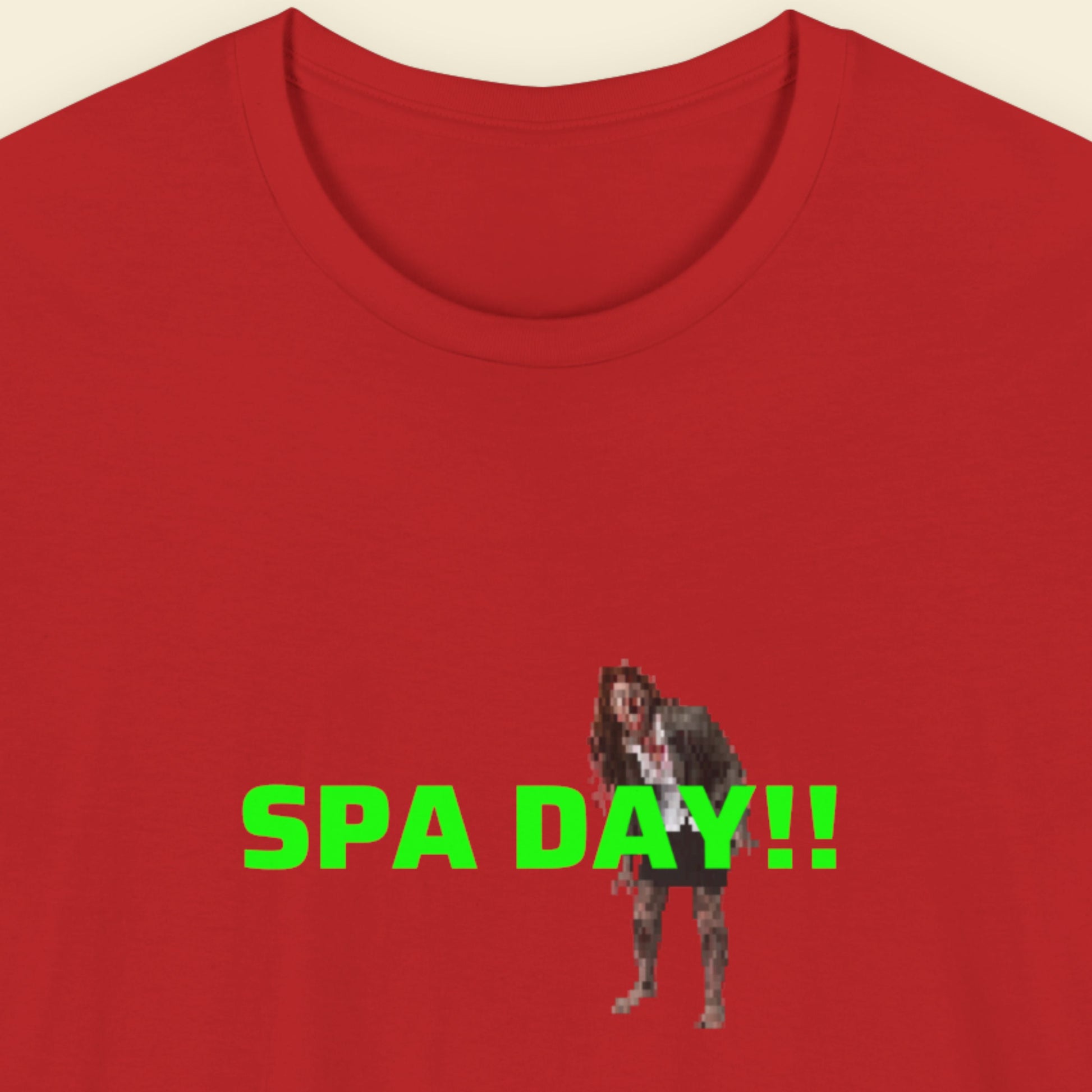 Red t-shirt with a graphic of a zombie person in a suit and 'SPA DAY!!' text in green on a beige background.