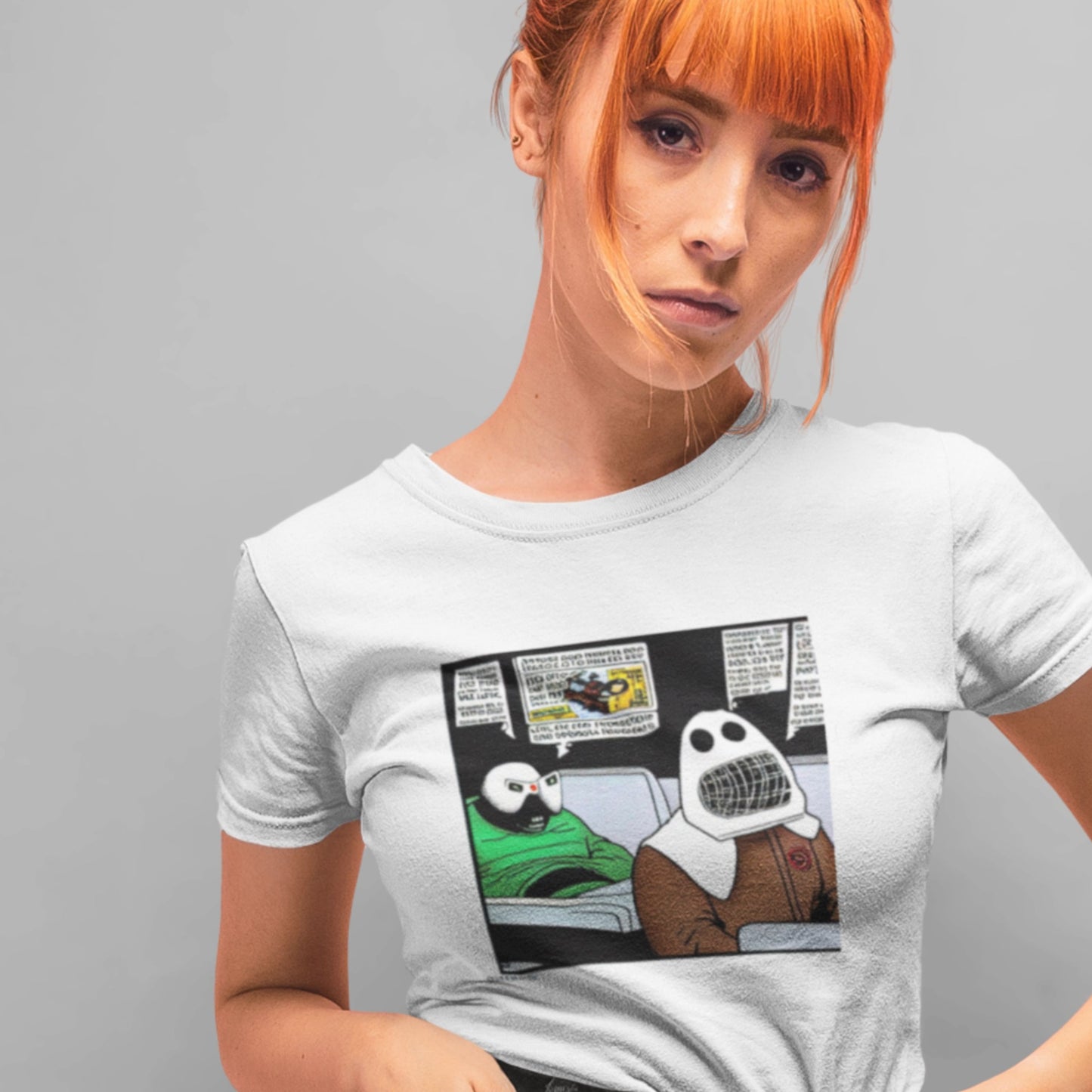 Person wearing a white t-shirt with a graphic design of a cartoon character in a car.
