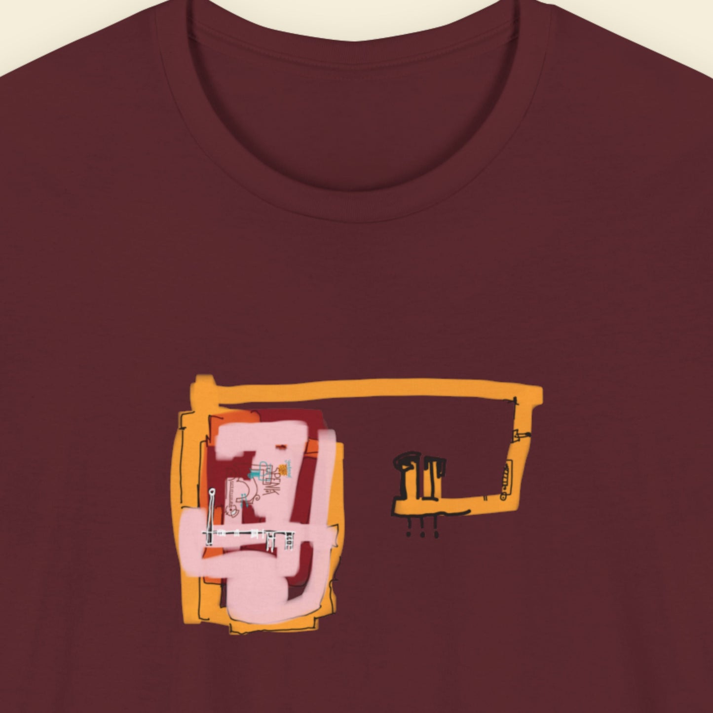 Maroon t-shirt with a colorful abstract drawing on a beige background.