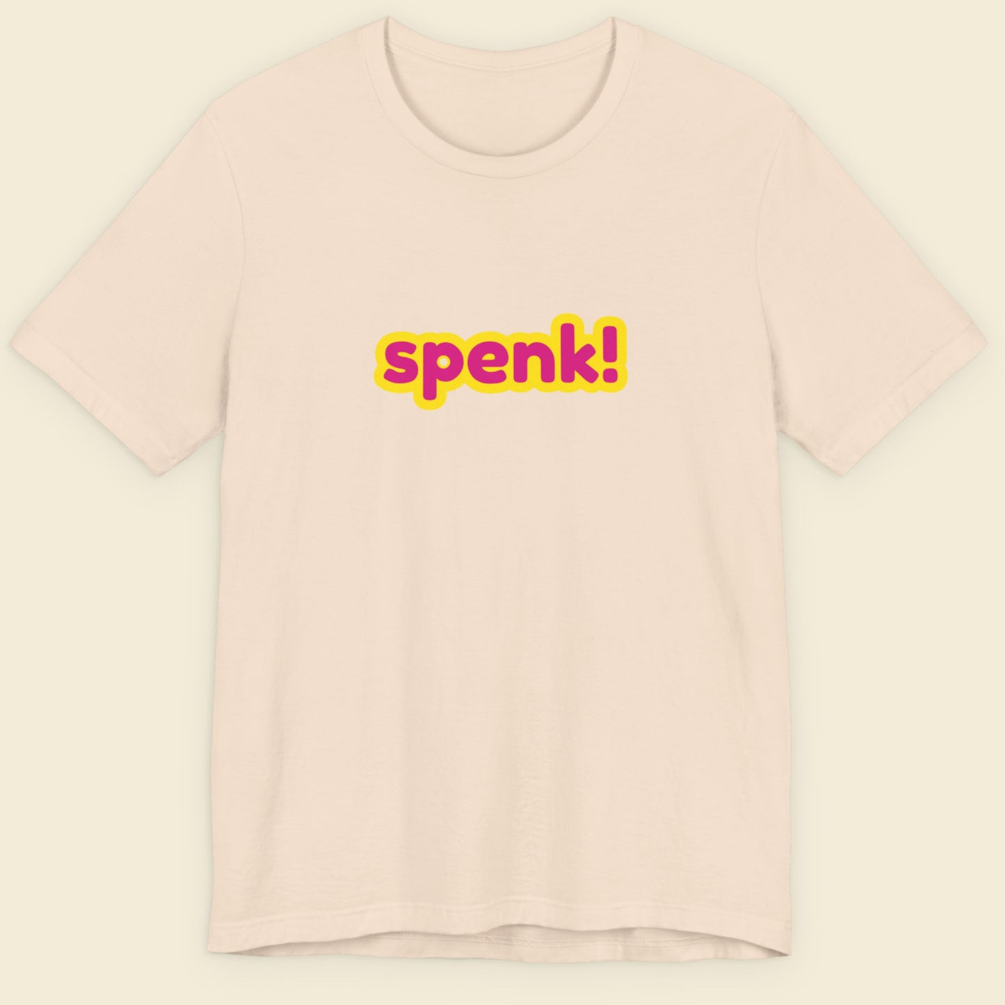 Beige t-shirt with multicolored 'spenk!' text on a beige background.