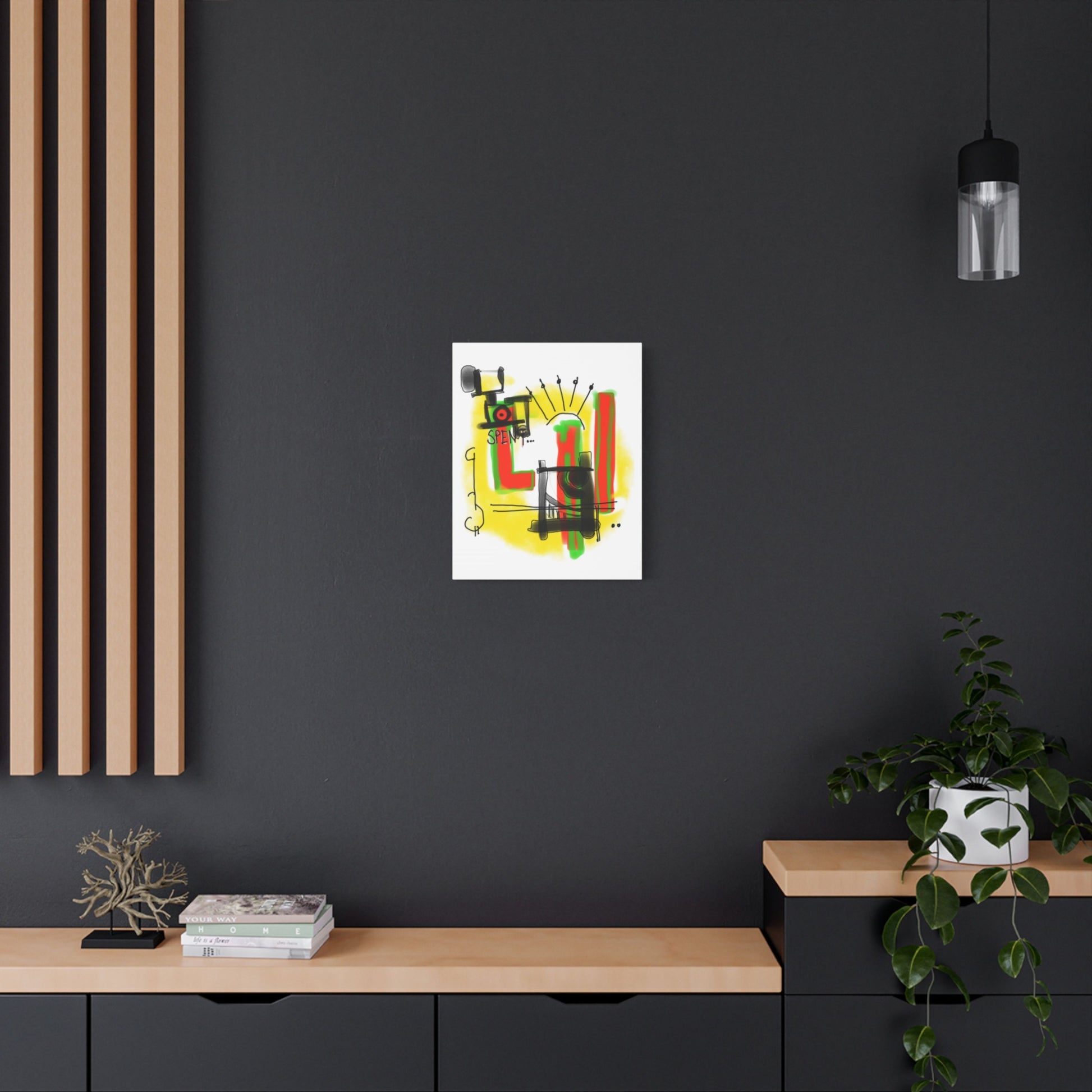 Abstract artwork on a black wall with a wooden shelf and plant in the foreground.