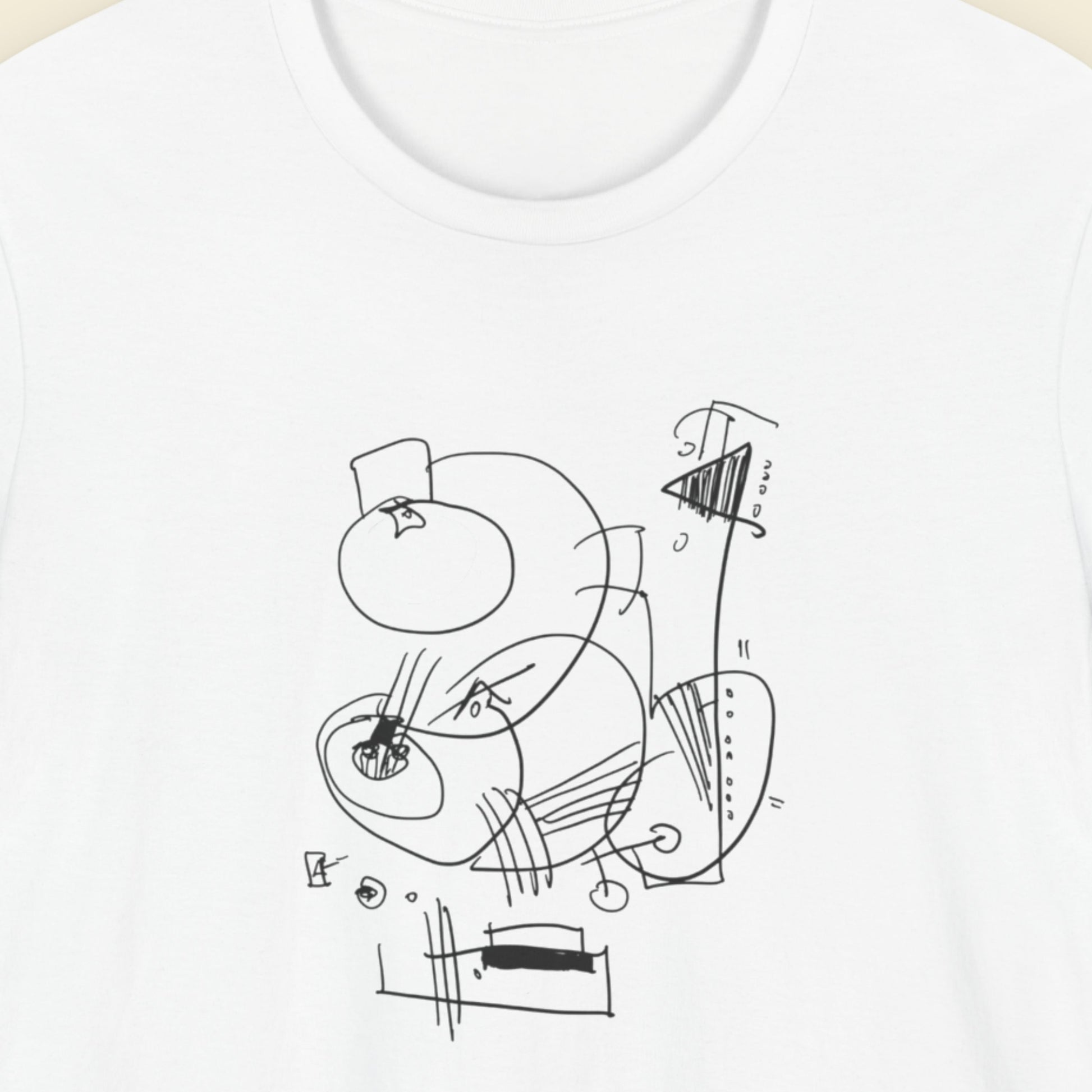 White t-shirt with an abstract line drawing on a beige background.