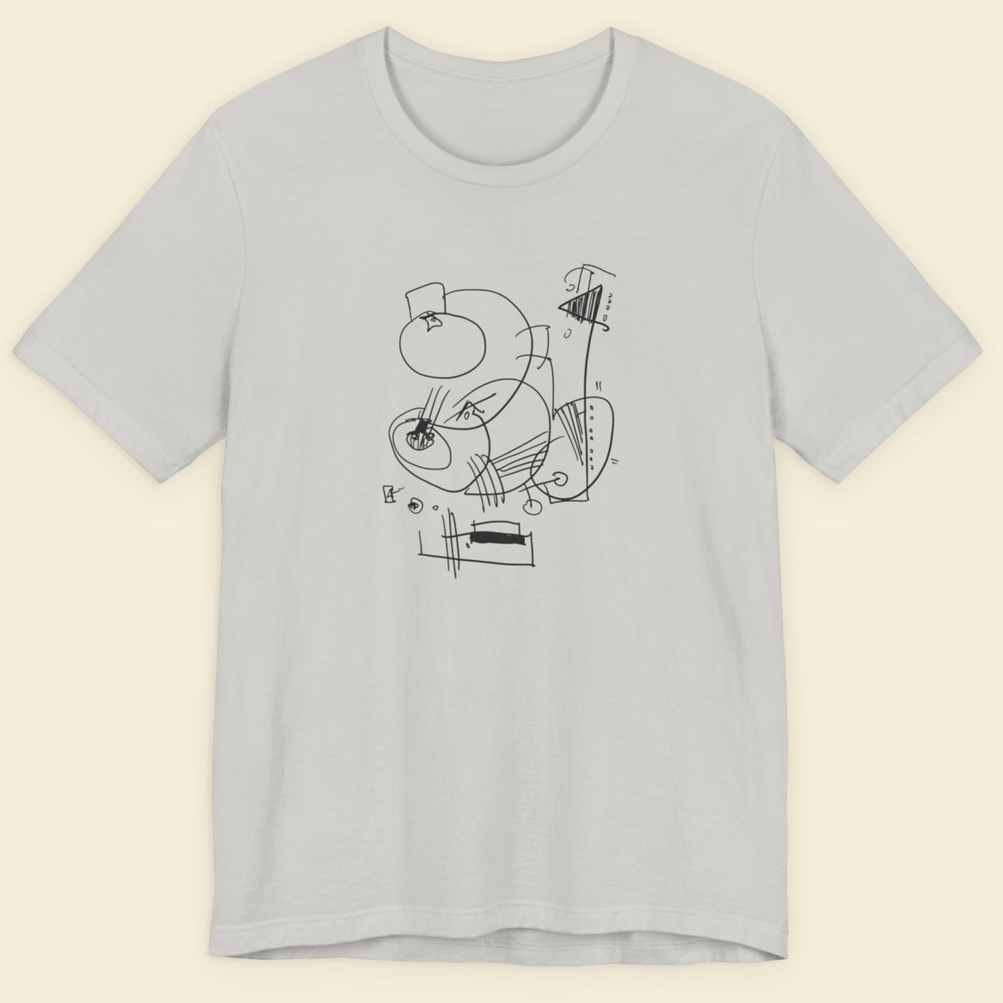 Light gray t-shirt with black abstract design on a beige background