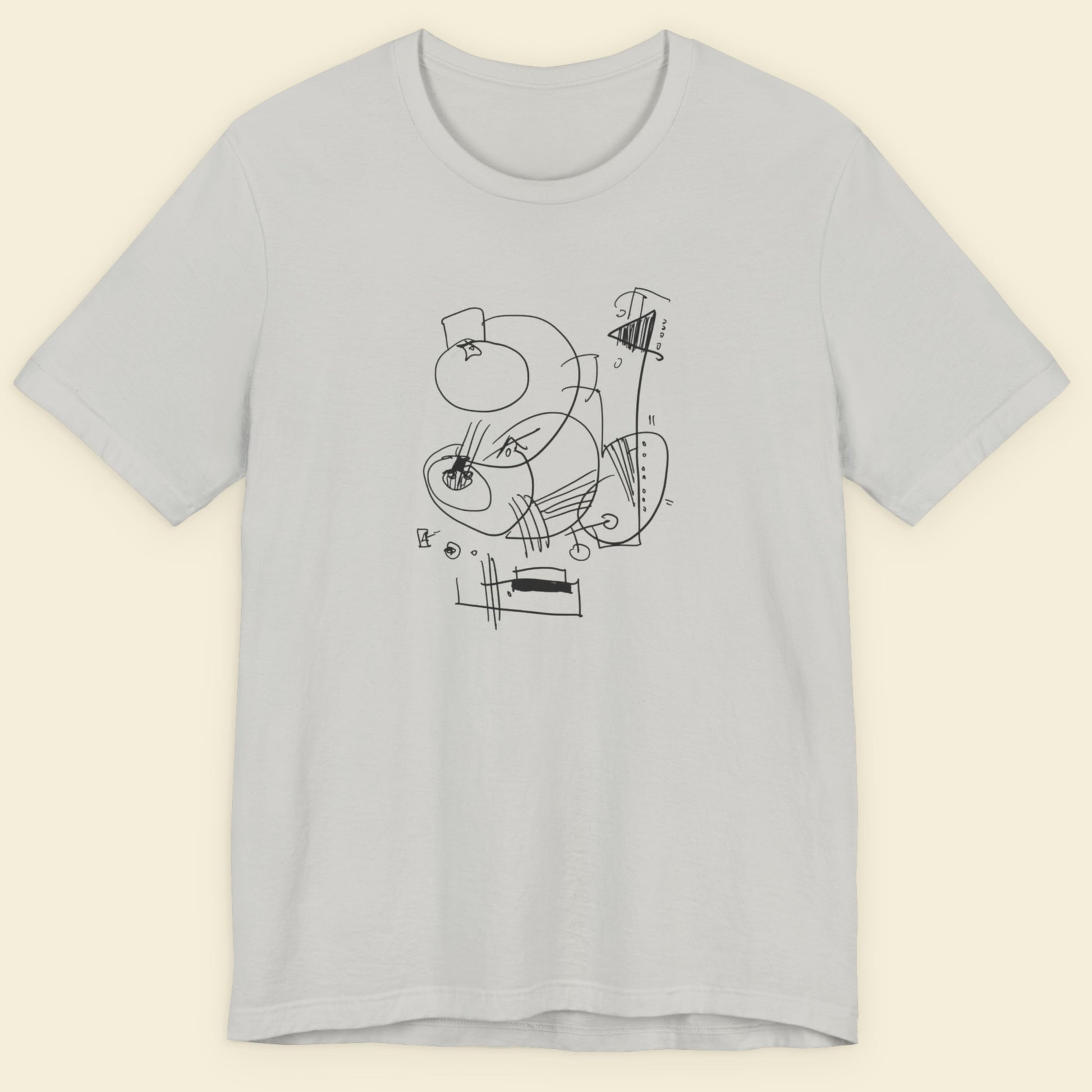 Light gray t-shirt with black abstract design on a beige background
