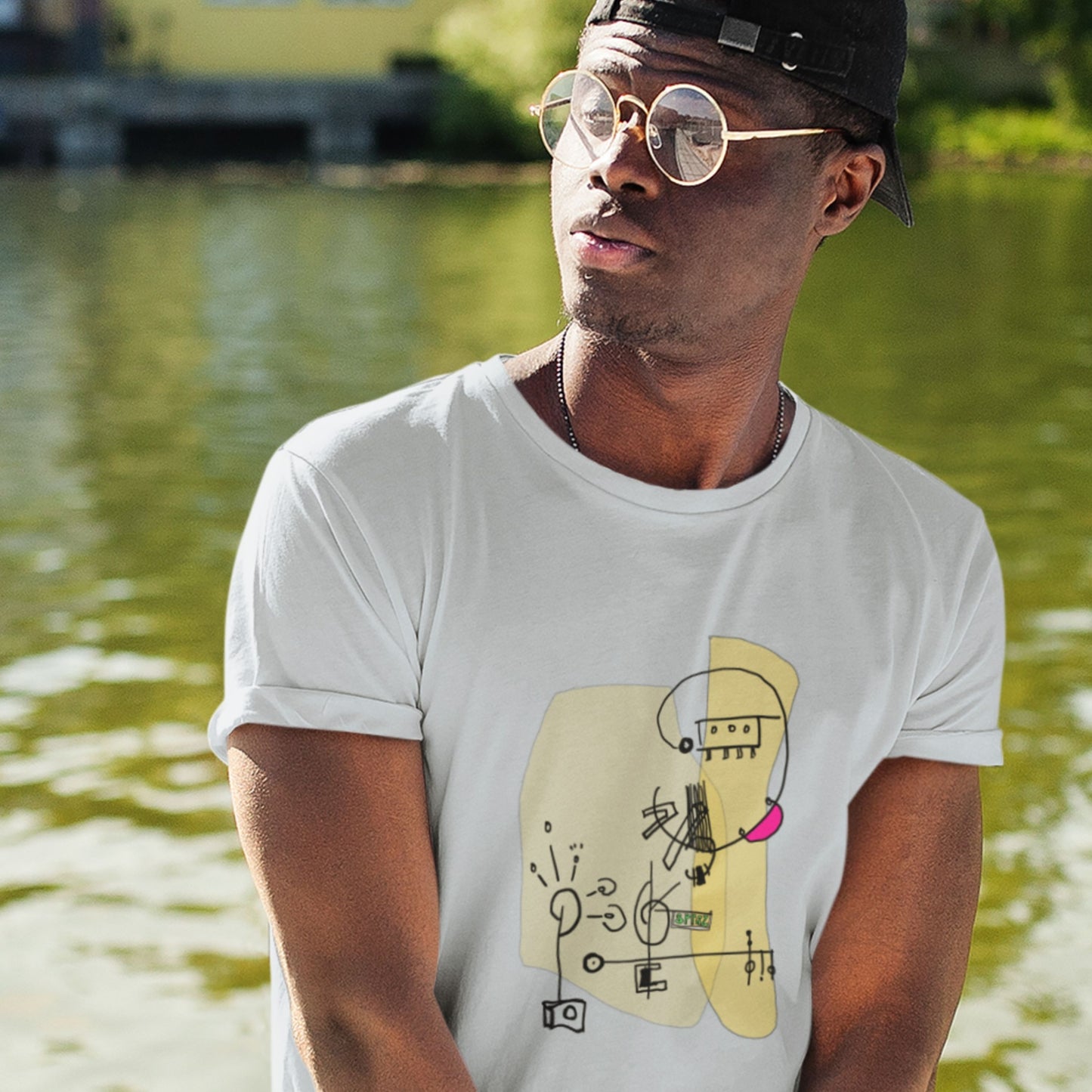 Man wearing a white tee with a colorful abstract drawing in the Boston Common.