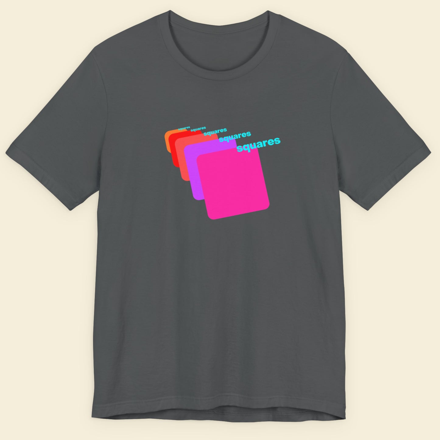 Gray t-shirt with colorful graphic design on a beige background.