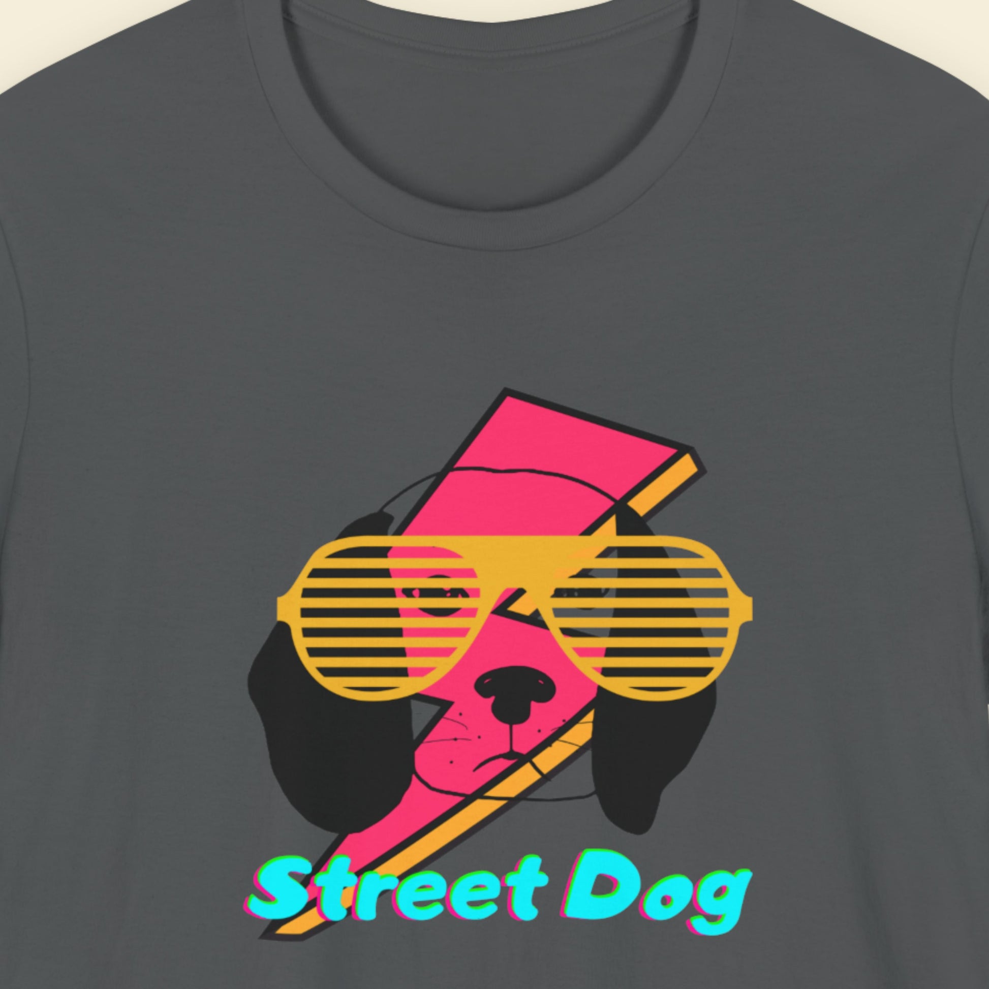 Dark grey t-shirt with a fun, colorful cartoon illustration on a beige background.