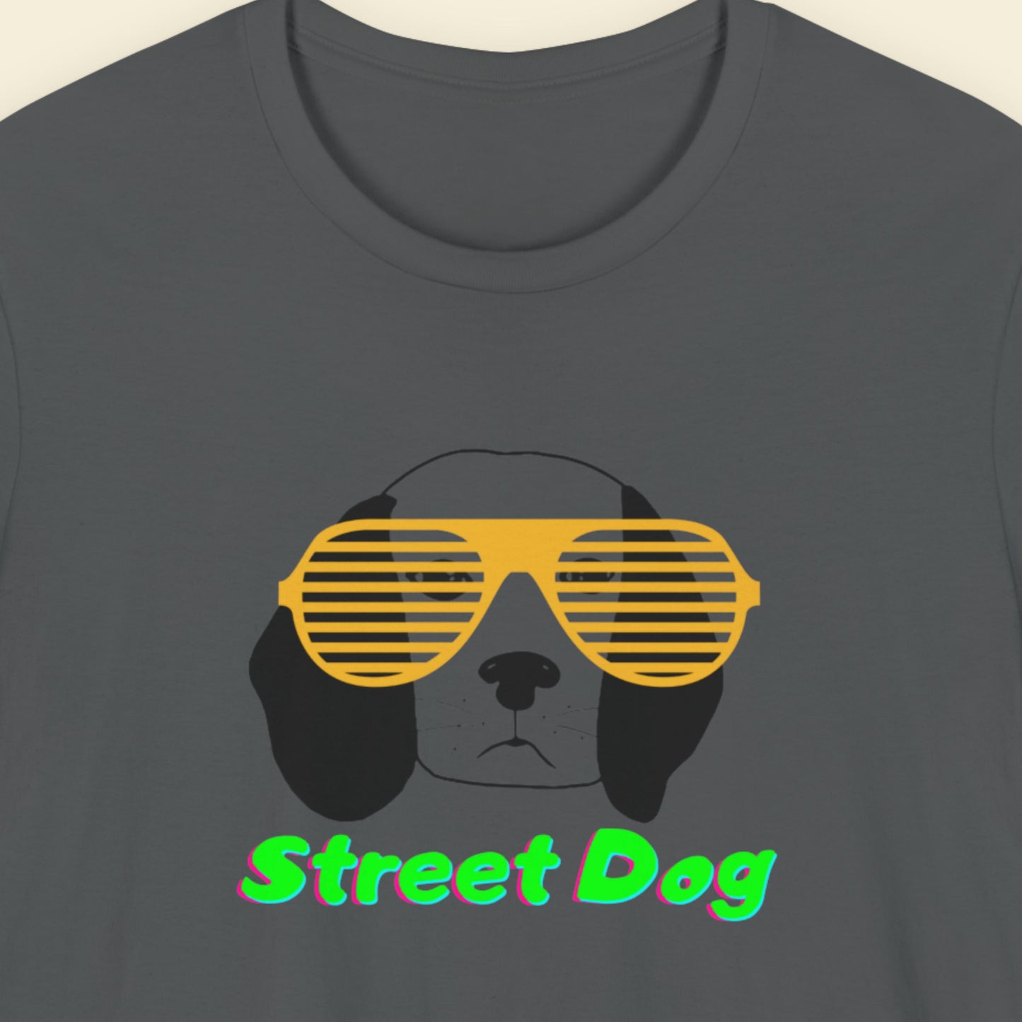 Dark grey t-shirt with a fun, colorful cartoon illustration on a beige background.