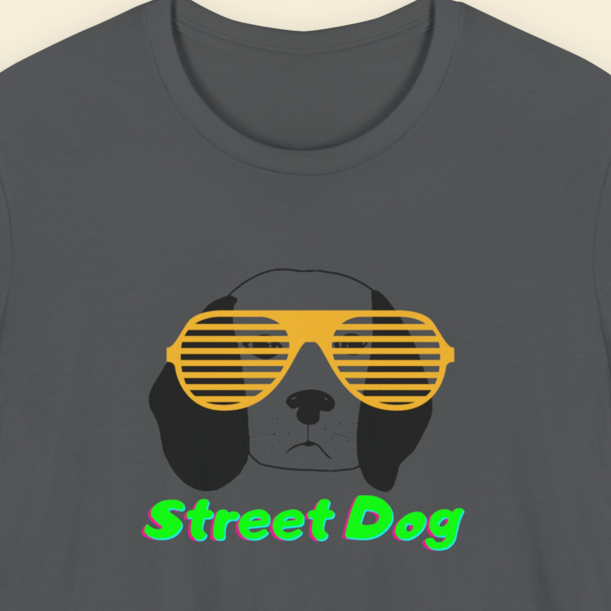 Dark grey t-shirt with a fun, colorful cartoon illustration on a beige background.