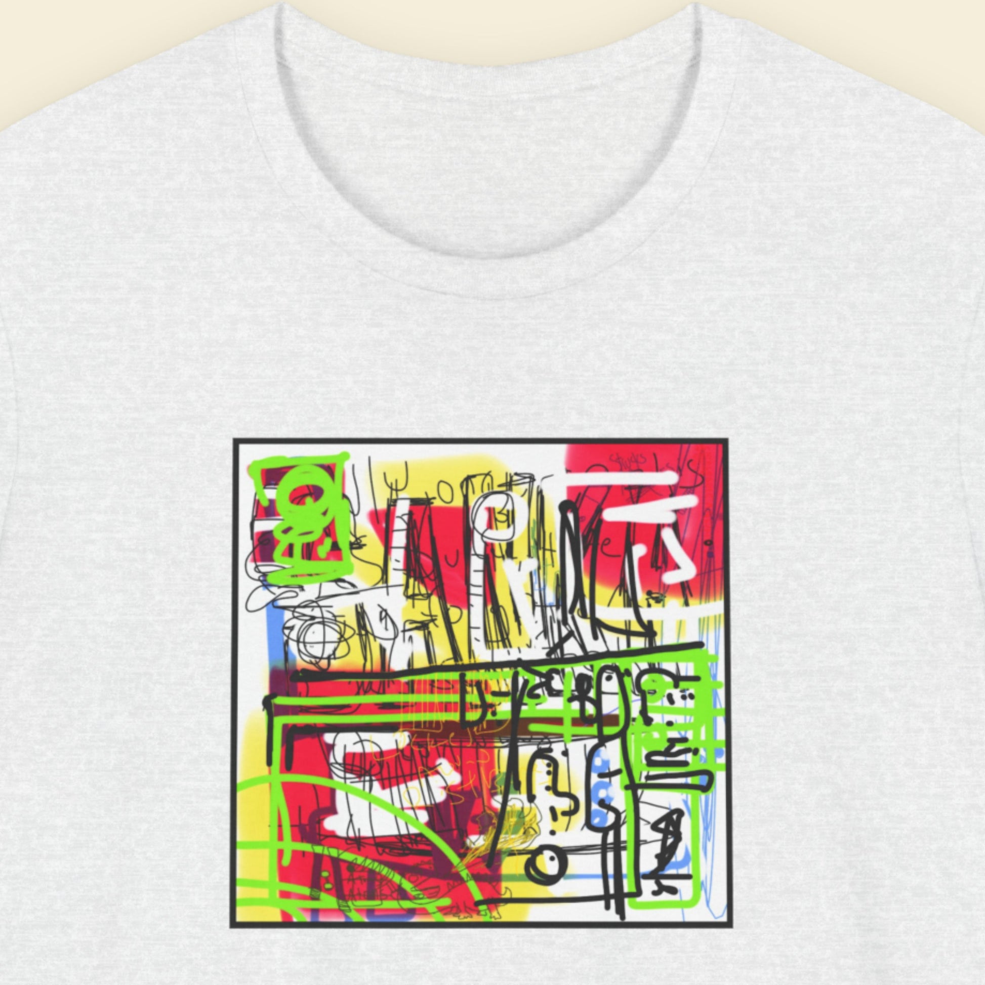 Ash grey t-shirt with colorful abstract design on a beige background.
