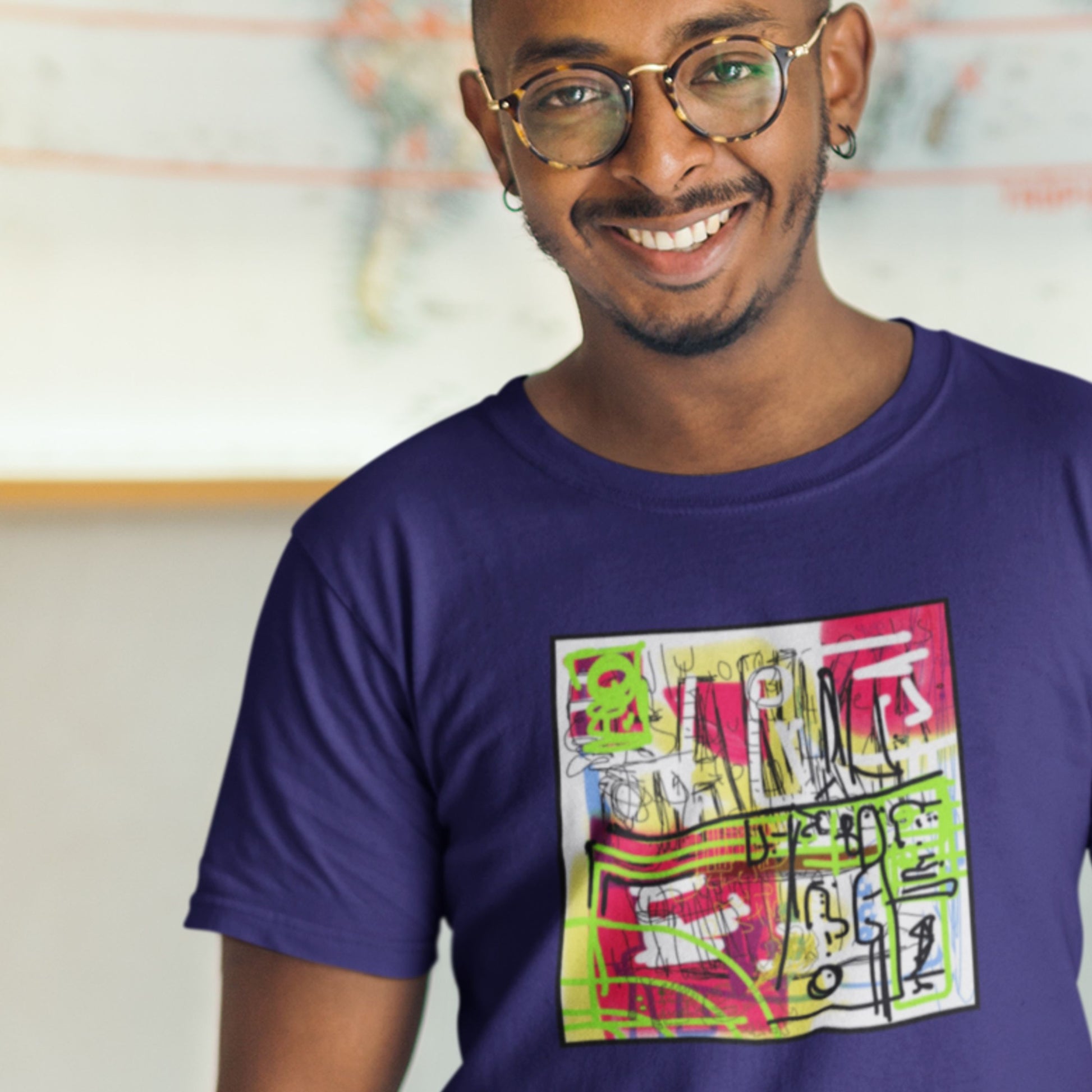 Man wearing a blue t-shirt with a colorful graphic design.