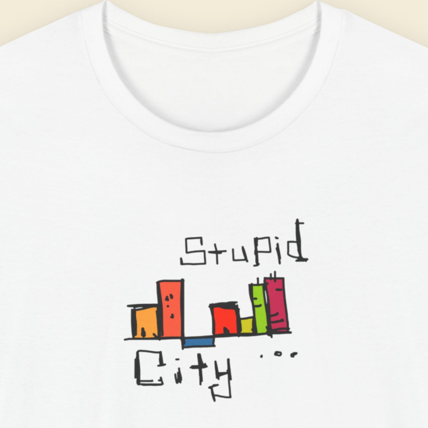 White t-shirt with colorful text design on a beige background.