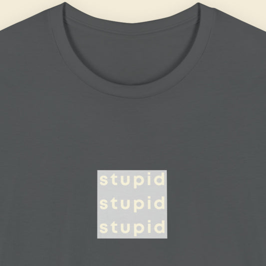 Dark grey t-shirt with humorous colorful text on a beige background.