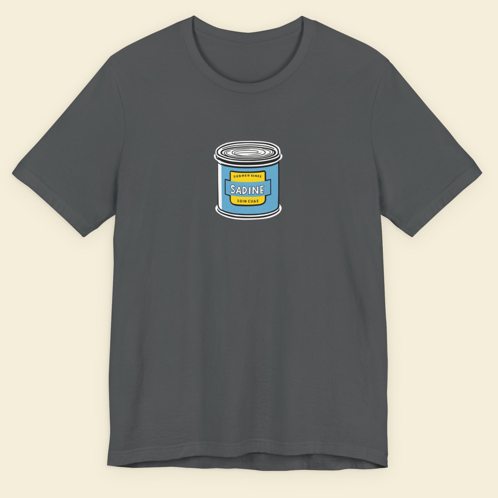 Grey shirt with an illustration of a can of fish on a beige background.
