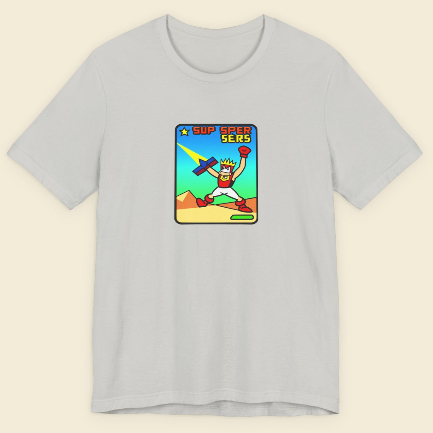 Light grey t-shirt with a fun, colorful cartoon illustration on a beige background.