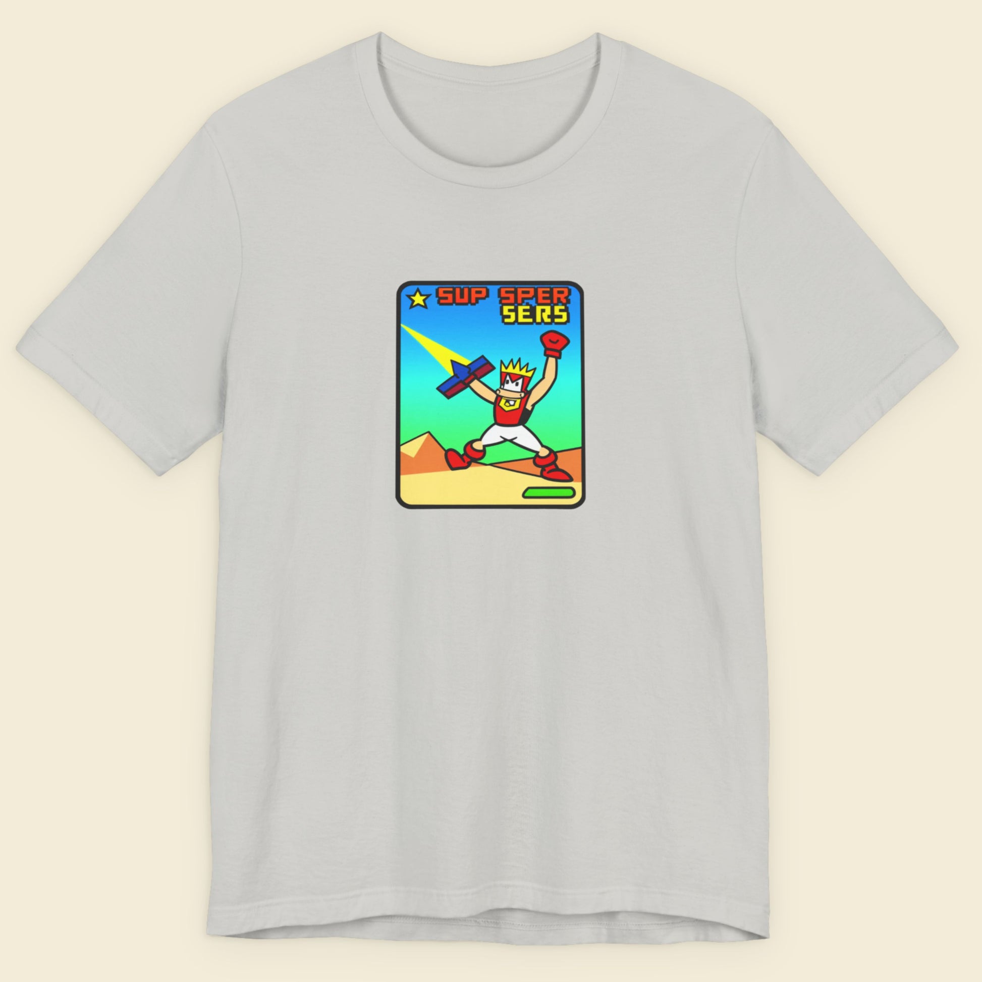 Light grey t-shirt with a fun, colorful cartoon illustration on a beige background.