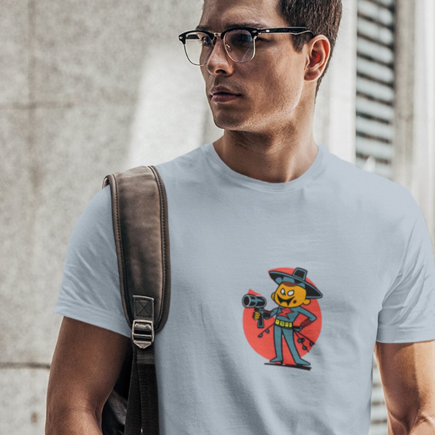 Busy man wearing a light blue t-shirt with a fun, colorful cartoon hair dresser illustration outside of a building.