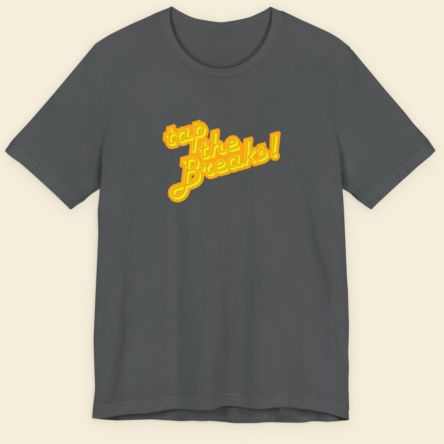 Grey t-shirt with humorous colorful text on a beige background.