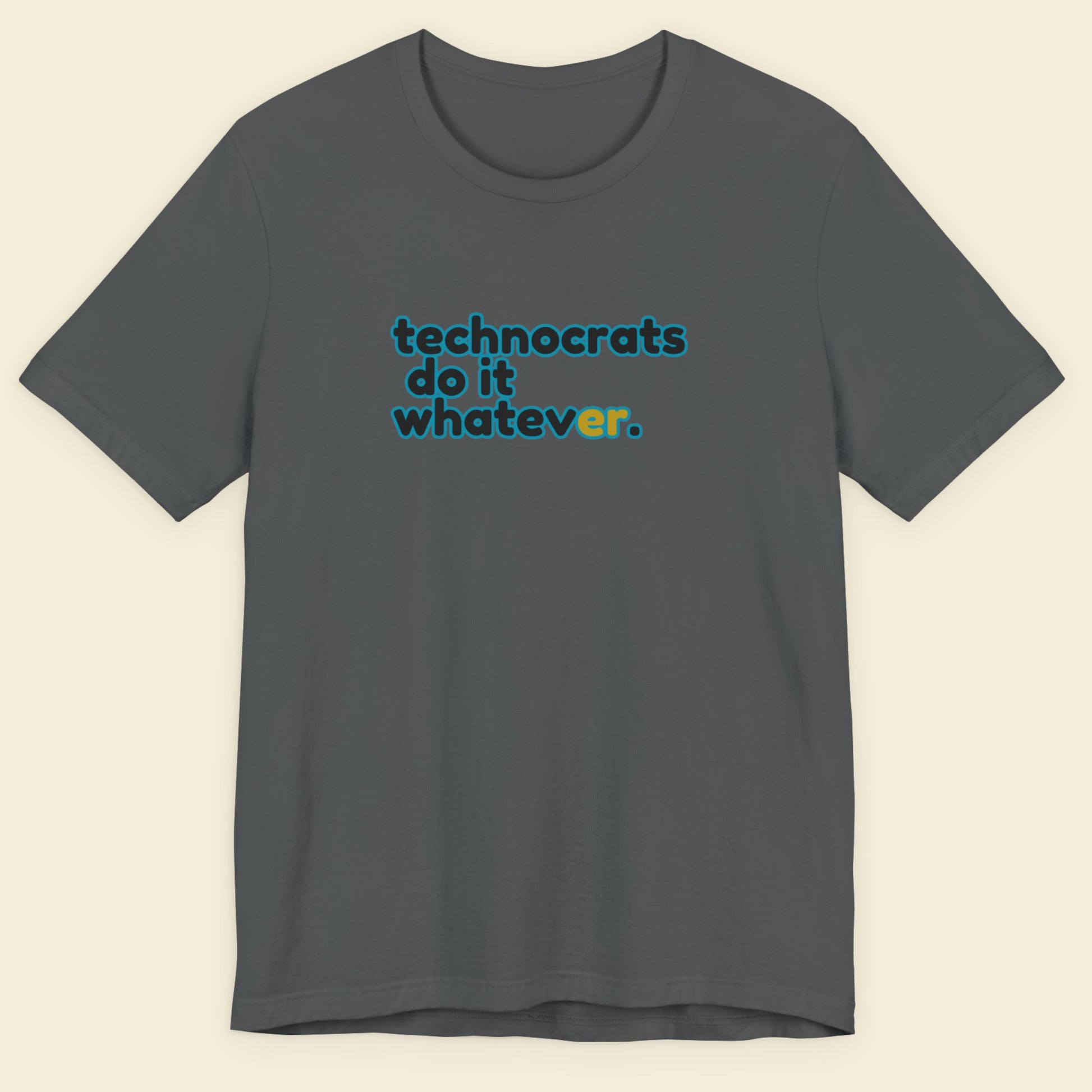 Grey tee with multicolored 'technocrats do it whatever' text on a beige background.