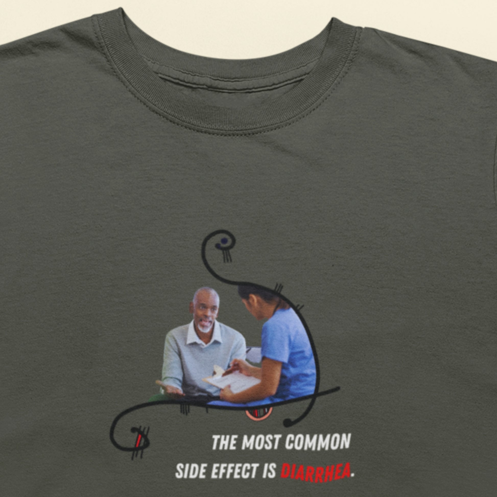 Gray t-shirt with a graphic of a doctor and patient and text on a beige background