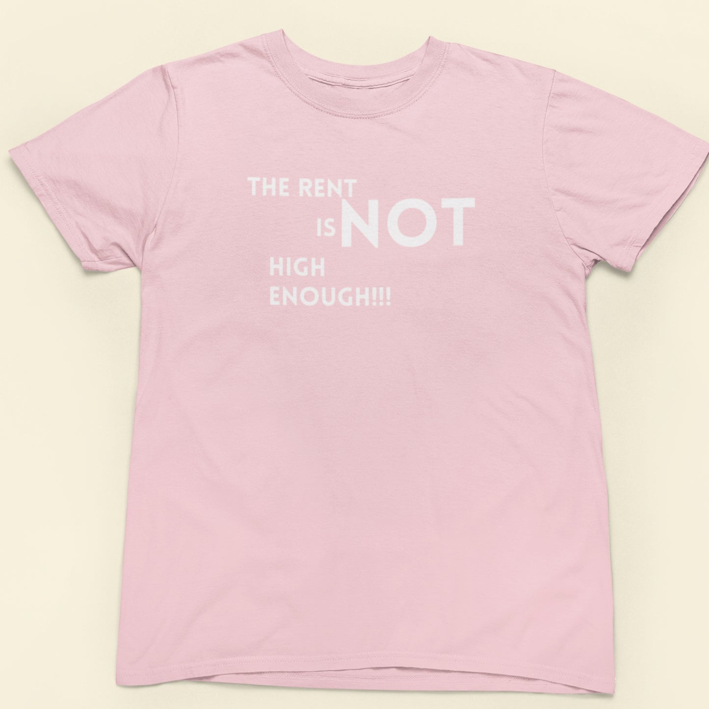 Pink t-shirt with white text on a beige background