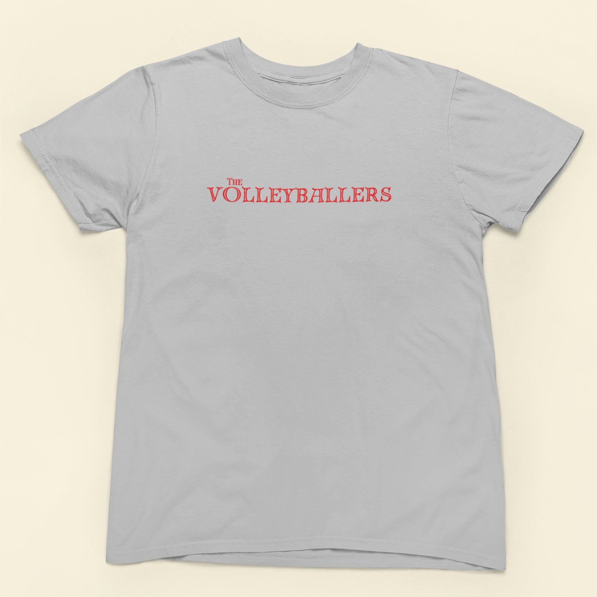 Gray t-shirt with 'The Volleyballers' text in red on a beige background