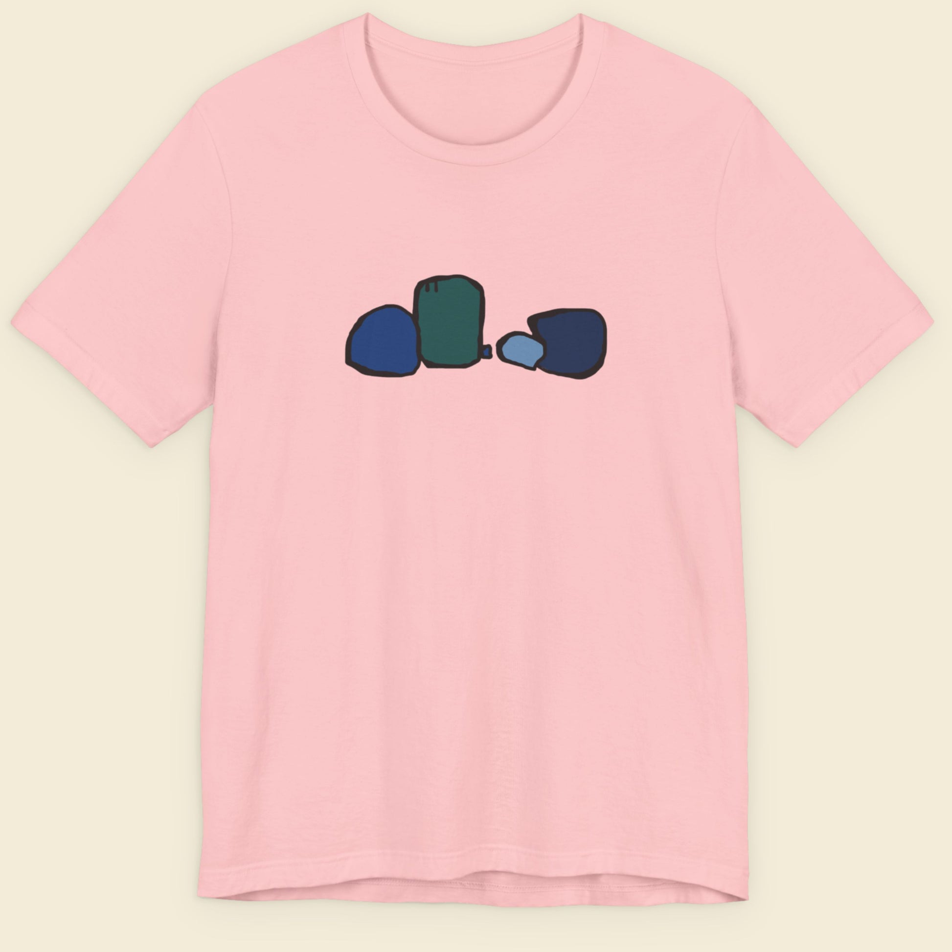 Pink t-shirt with colorful graphic on a beige background.
